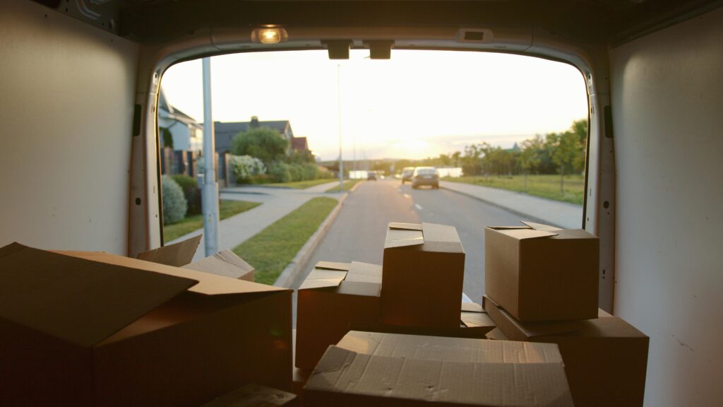 objets-encombrants-toulouse Transport d'objets encombrants et livraison à domicile from a delivery van loaded with cardboard boxes at sunset on a suburban street.